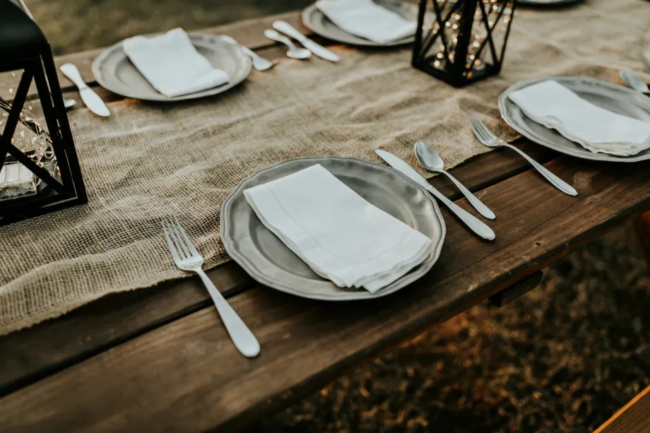 Plates and cutlery set out on a dining table