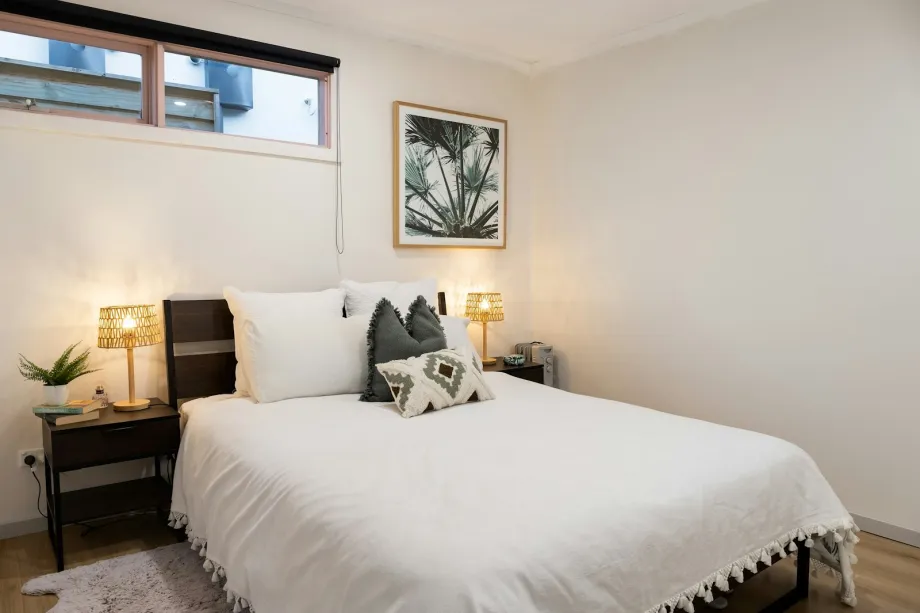 Bed with a thick white duvet and pillows
