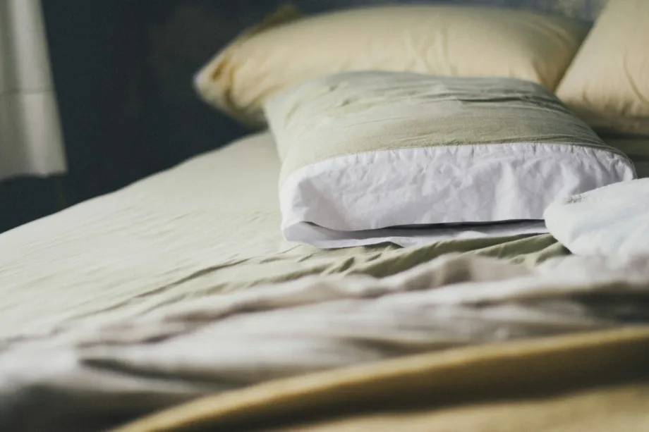 Made bed with a white duvet and pillows